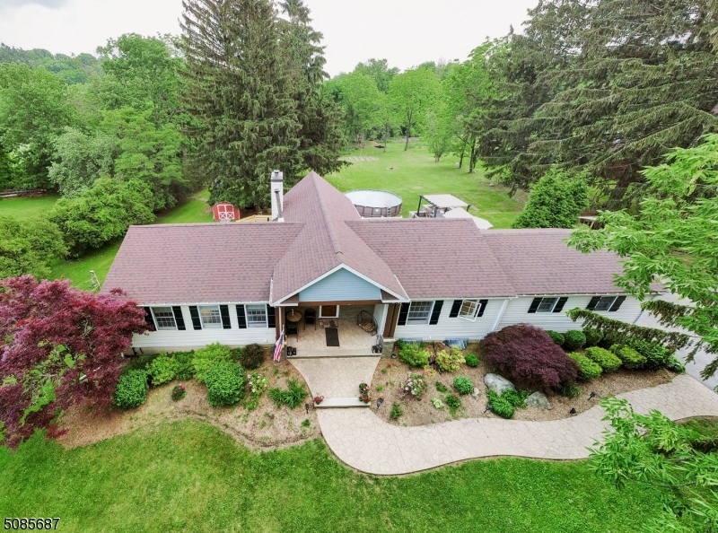 Truly one of a kind custom ranch has much to offer! The home boasts 3 bedrooms on the main floor with hardwood throughout, gourmet kitchen, updated baths, formal dining room and family room with high ceiling and a wall of windows which look out to the private parklike property. The lower walk out level is a complete in-law suite with kitchen, dining area, living room, office, and full bath. New roof in 2020 ,these are just a few of the finer points of this must-see home!