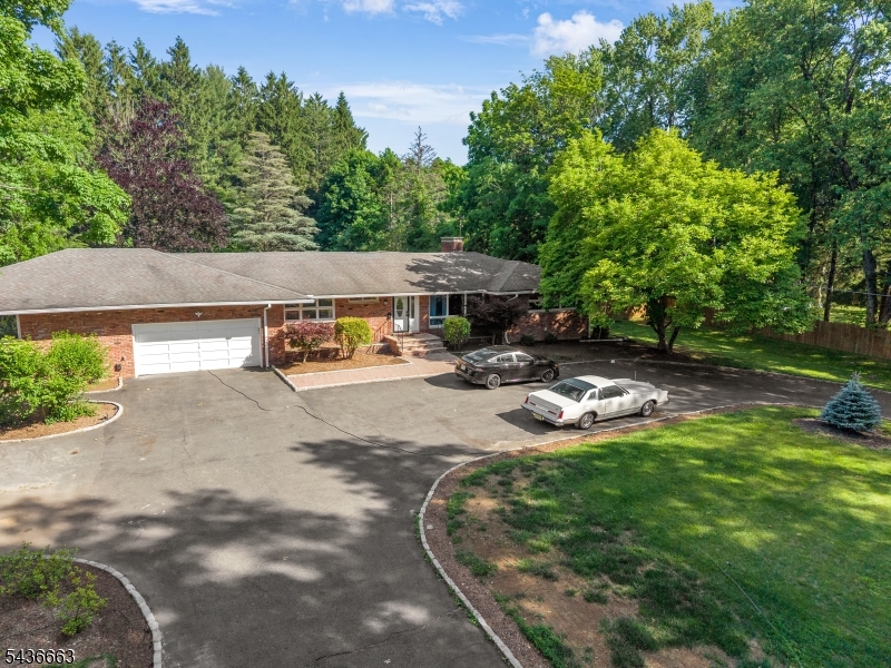 Exceptional custom ranch on over 2 private acres in the desirable Flanders section of Roxbury Township. offering approximately 3,200 sq ft of 1st floor living with a finished walkout lower level, this spacious home features 6 bedrooms, 4 full, & 1 half baths, updated kitchen, and a flexible layout ideal for expanded living, guests, or home office space. Sun-filled living areas, beautiful hardwood floors, central air conditioning, and generous room sizes provide comfort and functionality throughout. The walkout lower level includes additional living and recreation space, guest accommodations, and a sauna. Outdoors, enjoy a resort-style setting with an in-ground pool, expansive patio areas, mature landscaping, and beautiful property views. A circular driveway, attached garage, and ample parking add convenience and curb appeal. Conveniently located near shopping, dining, parks, major commuting routes, and highly regarded Roxbury Township schools. A rare opportunity to own a private retreat with exceptional space, amenities, and endless possibilities.