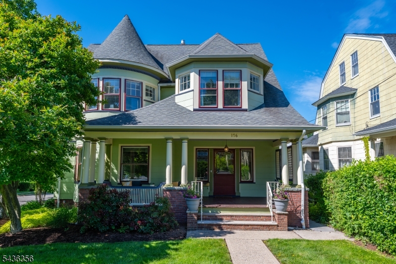 Gorgeous Queen Anne Victorian with sweeping front porch welcomes you to this treasure! The first floor sets the tone: hardwood floors, soaring ceilings, original ornate millwork, pocket doors, and a gas-burning fireplace in the living room. The eat-in kitchen comes fully equipped with stainless appliances, granite countertops, and a gas stove perfect for hosting weekend brunch or a Sunday dinner party. Natural light pours through the windows all day. The private backyard is a genuine standout: a custom paver patio, expansive pergola, manicured greenspace, and privacy fencing create a retreat that's equally suited to morning coffee, al fresco dinners, playdates or a summer hang. Two dedicated paved parking spots seal the deal. Up the curved staircase, you will find four gracious and spacious bedrooms and a beautiful updated full bath to give you flexibility for guests, a home office, a gym, or a creative studio. Head up to the third-floor primary suite  your own private floor. Two walk-in closets and a newly renovated ensuite make this feel less like a place to sleep and more like a reset button. The partially finished basement adds even more flex space- movie room, recording studio, work-from-home setup, you name it. The location puts the South End Business District, transit, schools, parks, and restaurants within seconds. Manhattan is 13 miles away, close enough for the commute or a night out, far enough to actually exhale.