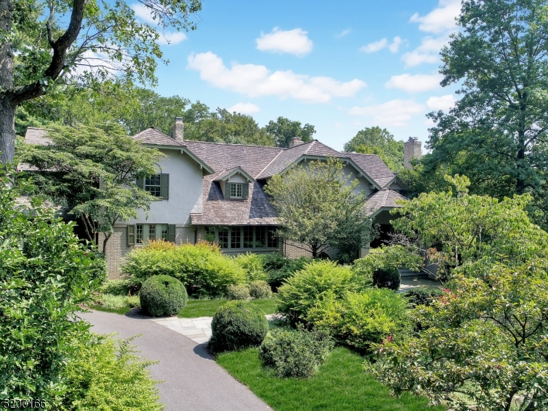 The old adage "Location Location Location" couldn't ring more true for this spectacular Old Short Hills estate, where sophisticated grandeur and understated elegance coincide. Majestically nestled in a park-like setting, this very special residence offers nearly one acre of complete privacy on one of the most sought after streets in all of Short Hills. This home is substantial with architectural interest at every turn, offering over 10,000 square feet of resort-like accommodations, impeccable attention to detail and quality levels so exceptional that nearly every other home pales in comparison. Showcasing a stunning design and expansion by renowned Hiland Hall Turner Architects, this home abounds with sun-drenched rooms, generous proportions, considerable custom millwork, expansive storage and flexible spaces for both work and play. Wine enthusiasts will appreciate two walk-in wine cellars surrounding a fireside tasting room while a generous wood paneled library will appeal to the literary connoisseur. Spacious rear patios offer an ideal setting for al fresco entertaining overlooking the manicured backyard. All new or renewed infrastructure and systems including cedar shake roof, four gas fireplaces, heat/AC, wine refrigeration, AV/sound, built-in generator, connected smart home, home security, interior/exterior painting and landscaping, creating the perfect move-in ready home. This one-of-a-kind quintessential residence is a rare opportunity that you will not want to miss.