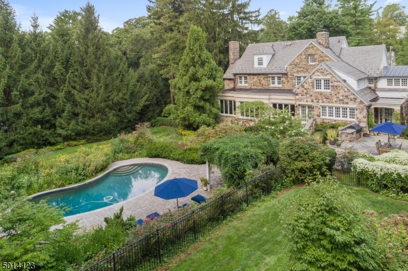 Once in a lifetime opportunity to own one of the most beautiful homes in Short Hills! This architecturally significant Historical home is ideally located on 1.37 acres of south facing, totally level beautifully manicured property with saltwater pool & perennial gardens on the most prestigious street in Short Hills! Original stone work, huge gourmet eat-in kitchen, library with mahogany built-ins, spectacular family room with cathedral ceiling, sunroom with floor to ceiling windows. Luxurious master suite with gas fireplace, 2 walk-in closets & spa-like master bath with radiant heated floors, 3 more bedrooms & 3 new baths on 2nd floor, 2 additional bedrooms with full bath on 3rd floor, beautifully finished walk-out lower level w/ rec/exercise room, billiard room & pool house bath. 4-car heated garage w/ loft.