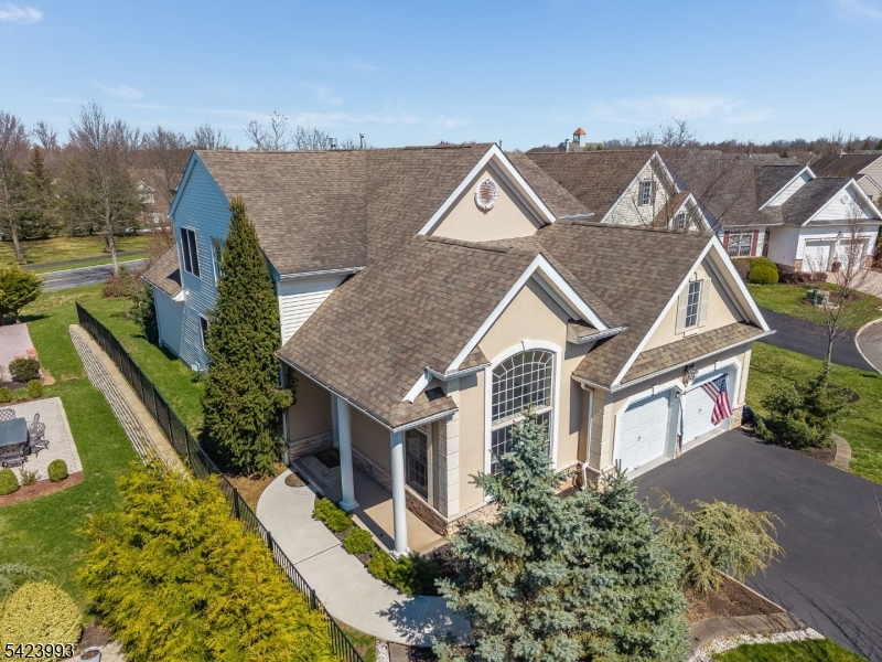 55+ Canal Walk!  Artistic Elegance Meets Garden Oasis. Once the builder's model, this Exeter floor-plan offers 3 bedrooms, office/sitting room, 2.5 baths, 2 car garage, and is located on a quiet cul-de-sac, showcasing the creative flair of the seller inside and out. As the original owners, they have lovingly curated a private sanctuary of trees and vibrant gardens to enjoy for years to come. Curb appeal with a long driveway, stucco front, gardens and a private side entrance. Beautifully appointed, the 2-story interior is defined by soaring ceilings, custom woodwork, decorator colors and gleaming wood floors that flow throughout the home. The living room with modern light-filtering zebra blinds leads to the formal 2-story dining room with a designer light fixture, and powder room.The heart of the home features a spacious kitchen equipped with an island, granite countertops, white cabinetry, and stainless appliances. Retreat to the family room and relax by the gas fireplace with marble surround, and sliders to the private back patio and views of the gardens. A serene primary bedroom & bath are conveniently located on the 1st floor and open to the office/sitting room. A clever floor plan adjustment moving the office/sitting room entrance away from the primary suite and to the family room would feel expansive and create a seamless flow. The 2nd level continues with the wood flooring, and provides a large loft, 2 bedrooms, full bath and a place for storage. Furniture negotiable.