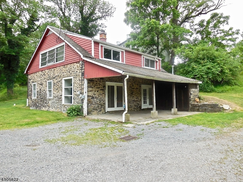 Charming 1800s carriage house/cottage situated on 2.26 acres on the corner of a private road. Open floor plan with first floor bedroom and full bath offers potential for an in-law suite, home office, or den.  The second floor has two large bedrooms, a full bath, and scenic countryside views.  The master bedroom features a walk-in closet and laundry.  French doors lead to a covered blue stone patio overlooking the pond across the road.