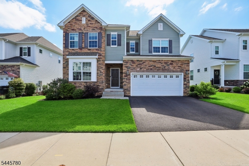 Located in the highly sought-after Anthem Place community of Tinton Falls, this beautifully appointed home, built in 2020, offers the perfect blend of modern design, comfort, and functionality. Off the open foyer, the elegant formal living room features custom wall molding, creating a refined space for entertaining or relaxing. The stunning open-concept kitchen showcases an oversized granite center island with an extended countertop, abundant cabinetry, and a custom-built dining bench with storage. Sliding glass doors lead to the expanded Trex deck with stairs to the backyard, creating seamless indoor-outdoor living. The first floor also features a warm family room with a gas fireplace, a bright corner office, and a convenient powder room. Upstairs, the spacious primary suite offers a luxurious en-suite bath and custom walk-in closet. A second bedroom also features a private en-suite, while two additional generously sized bedrooms share a beautifully appointed full bath. Every bedroom includes custom closet organization systems. The finished walk-out basement adds approximately 800 square feet of living space with a recreation room, full bath, and large storage area. Thoughtfully upgraded throughout, this move-in ready home is ideally located just minutes from major highways, shopping, dining, parks, and Jersey Shore beaches.