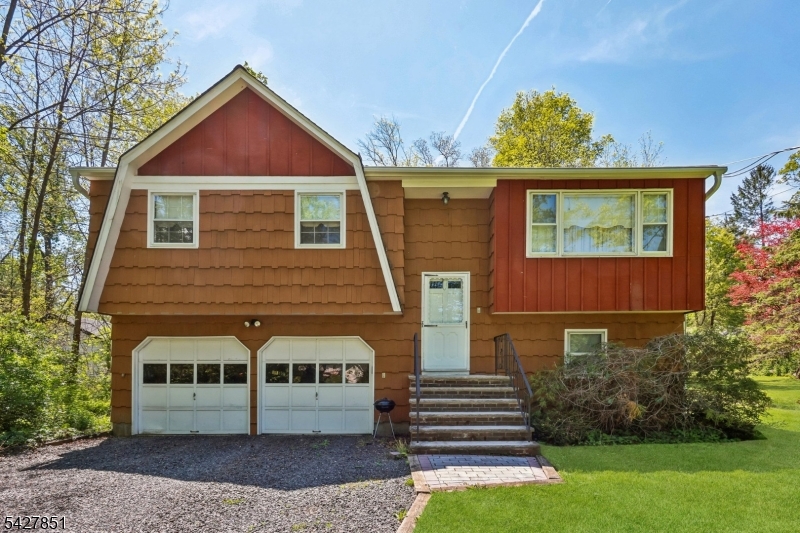 Spacious and well-maintained bi-level home set on a beautiful, private property in desirable Warren Township. Situated on a generous lot with mature trees and a large backyard, this home offers generously sized living spaces including a bright living room, formal dining room, oversized ground-level family room with backyard access, and eat-in kitchen with stainless steel appliances and abundant cabinetry. The primary suite features its own full bath, while additional bedrooms offer great space and flexibility. Additional features include central air, ample storage, and a 2-car garage. Lovingly cared for over the years and ready for its next chapter, this home presents a wonderful opportunity to update and customize to your personal style. Conveniently located near shopping, dining, parks, top-rated Warren Township schools, and major commuter routes.