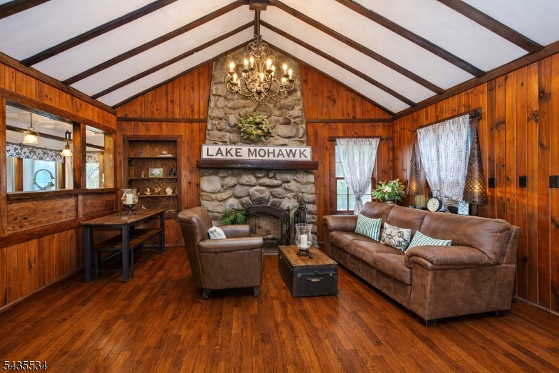 "ORIGINAL CRANE HOME"  Your year-round staycation starts here!  Imagine waking up to the charm of this storybook home nestled among trees, framed by stonework, and kissed by sunshine. Whether you're seeking a peaceful year-round haven or a clever vacation-home investment, this Lake Mohawk, Sparta gem delivers warmth, character, and timeless appeal. Some of the highlights include the corner property with seasonal lake views, a Juliet Balcony off the second floor en suite, and steps away from the secluded Toboggan Beach! Taxes are $8,854.00, a fraction of the price of owning a lakefront property. Additionally, this home includes a professionally installed generator transfer/interlock panel for portable generator hookups, providing backup power capabilities.  Easy access to major roads. 3-bedroom septic, town verified. Don't miss out on this rare find. Welcome Home.