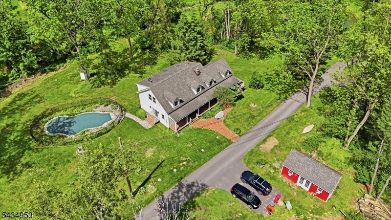Country estate on over 14 acres in Columbia, New Jersey, offering privacy, nature, and scenic beauty with a private pond, wooded areas, and open meadows. This thoughtfully designed home features an open-concept floor plan connecting the kitchen, dining, and living areas, creating an inviting space for everyday living and entertaining. The custom kitchen showcases beautiful stonework and tile, while the spacious primary suite includes a custom full bath. A dedicated study/home office provides flexible space for remote work or quiet retreat.The home offers 2 full baths and 1 half bath, plus a full basement with abundant storage and potential for recreation or workshop space. Outside, enjoy a custom in-ground heated pool, elevated deck overlooking the meadow and pond, wraparound porch, and French doors leading from a private family room. Two small barns/sheds provide excellent storage for tools, equipment, or hobby farming needs. A preserved historic outhouse adds charm and a connection to the property's heritage.Conveniently located near National Parks, local farms, the Delaware River, just 15 minutes to Pennsylvania, and under two hours from New York City, this unique property offers peaceful country living with accessibility. Property is close to routes 31,46,94 and 80.