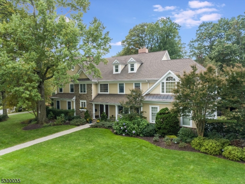A true forever home. this new construction colonial boasts luxurious touches around every corner - inside and out. A grand entry hall sets the tone for the expanse and elegance of this home. The main level offers a dynamic, yet comfortable flow, anchored by multiple fireplaces, with a formal dining room, the coveted "TV room off the kitchen" and a front great room. The open concept chef's kitchen is well equipped with a 6-burner range, custom range hood plus traditional and wall-mounted ovens. Additionally, there is a main floor laundry room and a custom built mudroom just off the 2-Car garage for added convenience. The second level features 5 bedrooms and 3 bathrooms, with a huge primary suite and two other ensuite bathrooms. On the 3rd floor you have a perfect in-law/au pair suite with a full bath, lounge area and large bedroom. The sprawling lower level comes with a half bath and tons of space for a rec room, gym, art studio and storage. The gem of the home is the brand new 4-season porch off the kitchen. Outside, you'll find an outdoor grilling station and a patio, perfect for hosting gatherings and enjoying the beautiful weather. The the expansive front yard mature landscaping provides plenty of space for outdoor activities. Located in a stunning neighborhood with winding streets and beautiful parks, this home is just around the bend from Brookdale Park and Upper Montclair Village.