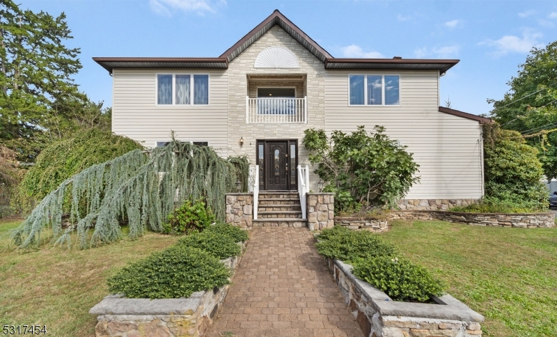 Welcome to 35 Kearney Ave in Whippany, a beautiful two-story colonial 4 bedroom 3 full bath home built on its existing foundation in 2001, charming stone steps, manicured landscaping, & a quaint balcony. Set in a peaceful neighborhood, this home is perfect for those seeking style and space. Step into the grand two-story foyer with gleaming hardwood floors and natural light. To the left is a spacious first-floor office or bedroom, across from a full bathroom. The hallway leads to a generous living room, ideal for gatherings. The 3-year-young kitchen is a chef's dream, featuring Italian marble countertops, Brazilian cherry wood cabinets, KitchenAid stainless steel appliances, a center island with stool-height seating, a skylight, backlit cabinetry, and wine fridges. A formal dining room adds extra seating for entertaining, & the laundry room with pantry provides easy access to the garage. Climb the striking staircase w/dark wood handrails & wrought iron balusters to the master suite offers a large walk-in closet, balcony access, and a luxurious bathroom with a jetted tub & standing shower. Two additional spacious bedrooms with ample closet space, a full bathroom, and extra storage complete the second floor. Outside, enjoy the 22x20 Trex deck and a fenced backyard. The full walkout basement adds extra potential. In addition to close convenience to shopping, highways, and restaurants, Hanover Township boasts LOW TAXES and an outstanding school system. Don't miss this one!