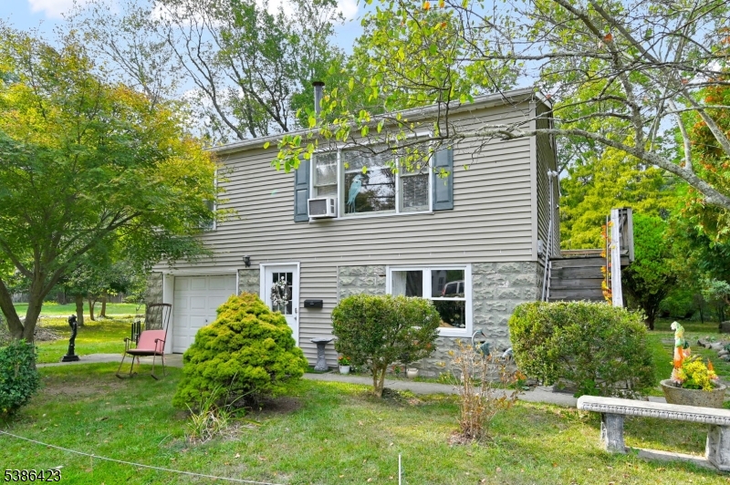 Well-Cared For Home With Flexible Living Space In Oakland, NJ! The Main Upper Level Has An Inviting Open-Concept Layout Featuring A Spacious Living Room With A Free-Standing Wood-Burning Stove And A Large Picture Window That Welcomes Abundant Natural Light. The Adjoining Eat-In Kitchen And Dining Area Flow Seamlessly Together, Offering Plenty Of Cabinetry, A Functional Center Island, And Sliding Glass Doors That Open To A Full-Length Rear Deck, Perfect For Outdoor Dining Or Relaxation. This Level Also Includes A Generously Sized Bedroom, A Full Bath With A Tub/Shower and Laundry and Utility Room. The Lower Level Expands The Home's Versatility With Its Own Private Entrance, A Kitchenette With Sink And Refrigerator, A Comfortable Living Space, 2nd Bedroom, A Bonus Room, And A Full Bath With A Stall Shower. This Space Offers Endless Potential, Whether For A Home Office, Recreation, Hobbies, Or Creative Uses. Set On A Peaceful Level Property With Mature Landscaping, Outdoor Seating Areas, And Tranquil Water Views, This Home Blends Convenience With Charm. Ideally Located Just 2 Miles From The Oakland Transit Park & Ride And Within Minutes Of Major Highways Including Route 287, Route 202, And The NY Thruway, This 2-Level Residence Is Perfect For Both Commuters And Those Seeking Flexible Living Options.