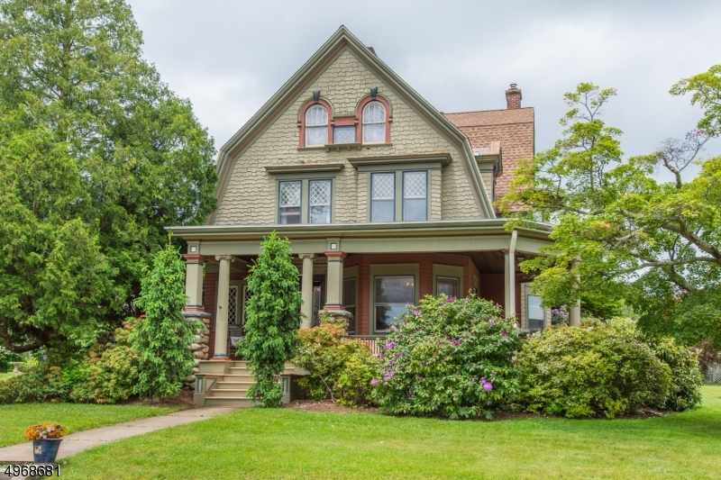 Steeped in history, this gorgeous Victorian offers so many living situation possibilities!  The main house features wood flooring, extensive moldings, charm, character and many updates/upgrades.  Step off of the covered wrap-around porch into the waiting room and be greeted by an incredibly detailed warm wood reception area with beamed ceiling and stone woodburning fireplace.  Front parlor is open to the back parlor through impressive oversized pocket doors.  Formal dining room is large enough to accommodate the largest dinner party prepared in a chef sized kitchen with Silestone counter tops.  The second floor offers 4 ample sized bedrooms and 2 full baths.  A full staircase to the 3rd level leads to a bedroom plus additional living/storage space. Carriage house features a huge 2 car garage & apartment above.