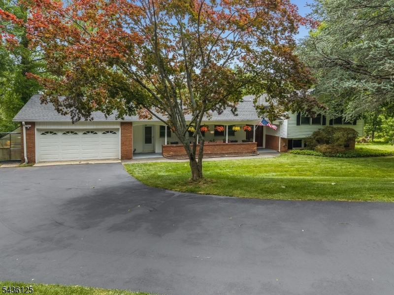 Prepare to be surprised! This Gorgeous home is much roomier than it appears from the exterior. Welcome to your private 2.4 acre retreat (per tax data).Tucked back from the road, this spacious 4-bedroom, 2.5-bath home offers 3,322 sq ft of light filled living space across three beautifully finished levels. June 2026 GAF Roof with a 50-year transferable warranty. Sparkling hardwoods, formal living and dining rooms w/crown molding, & a flexible sunroom/bonus room. The kitchen boasts solid oak cabinets, granite counter tops, Quoizel lighting, & stainless steel appliances, right next to a massive mudroom/laundry room. Four spacious bedrooms - all w/hardwood floors. The primary suite features a walk-in closet and en suite bath. A massive secondary living space featuring a cozy brick fireplace, custom built-ins, a half bath, & a home office/gym space. Sliding doors lead to an expansive deck with built-in seating overlooking the woods. Breathtaking Views. Includes a hobby greenhouse w/a potting bench and a storage shed. Enjoy the perfect blend of seclusion and convenience. In addition to the Roof replaced: Recent Upgrades and Extras: Pre-listing inspection, seller proactively tested PWTA treated, & now passed. Septic inspected w/repair completed, Radon tested, mitigation system installed. Driveway repaired and sealed. Just minutes to historic downtown Clinton Round Valley Reservoir recreation, and commuter-friendly Routes 31 & 78. Don't forget to watch the VIDEO TOUR.