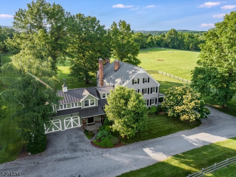 Hunting Creek Farm is a rare equestrian offering in the heart of the Essex Hunt country.  This 43.39 acre preserved farm is surrounded by hundreds of acres of farmland, and is beautifully situated on one of the most scenic roads in Tewksbury Township.  A three-story historic stone and clapboard barn dates back to the late 1800s and offers seven stalls, a renovated caretaker's quarters, heated wash stall, laundry room, tack room, blanket room, feed room and half bath.  An outdoor riding arena, two-stall shed row adjoined by a small paddock, tractor shed and approximately twenty-six acres of open and fenced pastures complete the equestrian infrastructure. There are also woodlands with trails and a ten-acre hayfield that is harvested annually. The custom Colonial home was completely renovated in 2012 under the watchful eye of the current homeowners and the skilled craftsmen at Eberle Builders.  The quality of the renovation resulted in a newer home with the soul and ambience of an antique gem.  Intricate millwork and moldings, refinished random-width wide plank pine floors and four unique wood-burning fireplaces grace the spacious floor plan.  The family room and a delightful sitting room are both open to an expansive gourmet kitchen with  custom alder wood cabinets, hammered granite countertops, upscale appliances and a large center island with a walnut countertop.  The front porch and the bluestone patio offer the ideal venues to enjoy the views of this incredible setting.