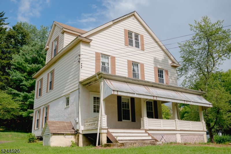This charming colonial sits high up overlooking the parklike double lot. Relax and take in the peaceful views on the huge covered wrap around front porch. The woodwork and craftsmanship throughout this home add classic charm. Large formal dining room, living room and family room.  Plumbed for a second full bathroom on the third floor.  Large storage shed. Tremendous potential to add value on this beautiful home or move right in and make it your own.