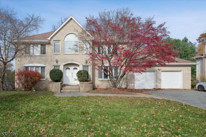 Discover the potential of this spacious brick-front Colonial set in the highly sought-after South Powder Mill section of Morris Plains, an exceptional location known for quiet streets, nearby parks, and convenient access to NJ Transit direct train to NYC, shops, and major highways. South-facing and filled with natural light, this home offers generous space and a wonderful opportunity for a new owner to add personal touches. Step inside to an open foyer that leads to a bright formal living room and dining room with large windows and hardwood floors. The eat-in kitchen, with sliders to an oversized deck, flows into the warm family room featuring a gas fireplace. This level also includes a convenient first-floor bedroom, an adjacent full bath, and a laundry room. Upstairs, the expansive primary suite features a walk-in closet, gas fireplace, and a skylit bath with a jetted tub and stall shower. Three additional bedrooms offer double closets, hardwood floors, and architectural details such as a cathedral ceiling and Palladian window. A full hall bath with a double vanity completes this floor. The full walkout unfinished basement provides endless possibilities for storage, recreation, or future finishing. A 2-car garage and large driveway add to the home's value. Home is being sold strictly "as is" a rare chance to bring your vision and create the home you've imagined in a prime Morris Plains location.