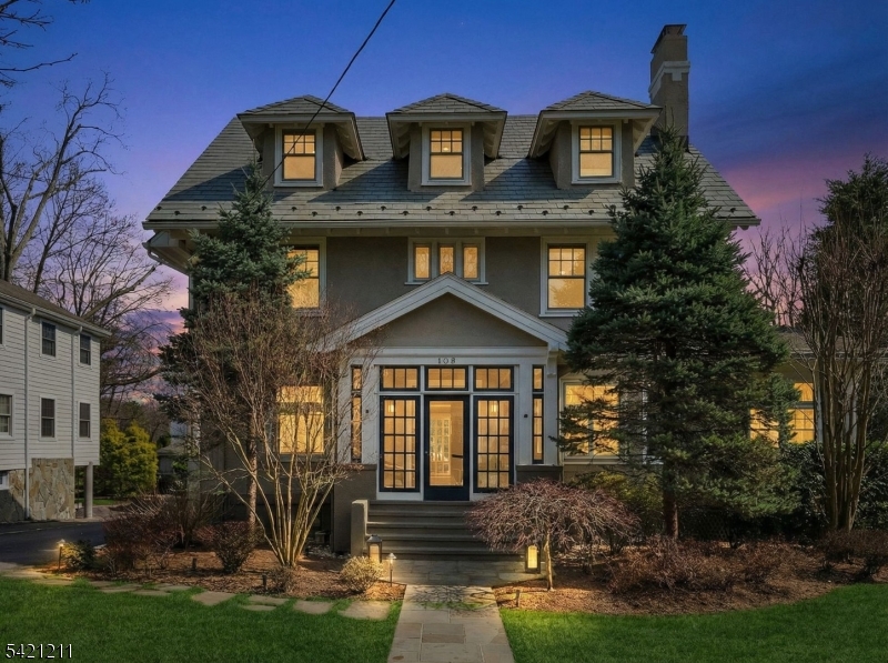 Ideally located just a block from Maplewood Village, this beautifully updated 1910 Colonial set on an expansive, professionally landscaped property that seamlessly blends timeless character with modern upgrades. Original details include leaded glass windows, French doors and impressive millwork throughout. Featuring a gracious double living room with a gas FP, leading to a generously sized DR that's ideal for entertaining. A dedicated office provides 2 built-in workstations & extensive custom bookcases. The chef's kitchen, outfitted w large center island, prof-grade appliances, three sinks and a walk-in pantry, opens to a sun-filled FR designed for everyday living & hosting, while nearby mudroom, PR & FB complete this level. Upstairs, an expansive primary suite with gas fireplace, walk-in closet and spa-like bath, is complemented by four additional bedrooms, one and a half additional baths, convenient second floor laundry and a family room that opens to a private sundeck. Downstairs, the spacious lower level includes a Universal Gym, game room and ample storage. Outdoor living is equally impressive, showcasing a heated in-ground pool with underwater lighting, a fully fenced backyard and beautifully maintained grounds with irrigation and landscape lighting. Additional features include a two-car garage with EV charging, owned rooftop solar panels and a comprehensive smart home system controlling thermostats, lighting, and five-zone audio throughout the home and outdoor spaces.