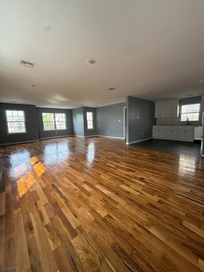 Huge 3-bedroom, 2-bath second-floor apartment in a newer two-family home built in 2019. Designed with comfort and functionality in mind, this newer unit offers an open-concept living and dining area, gleaming hardwood floors throughout, and abundant natural light. The oversized layout provides significantly more living space than typically found in two-family homes. The primary bedroom features a private en-suite bath and a generous walk-in closet. Two additional bedrooms offer ample space and closets. Enjoy the convenience of in-unit laundry, central air conditioning, and modern finishes throughout. Excellent condition and move-in ready. A rare opportunity to enjoy newer construction, spacious rooms, and contemporary living.