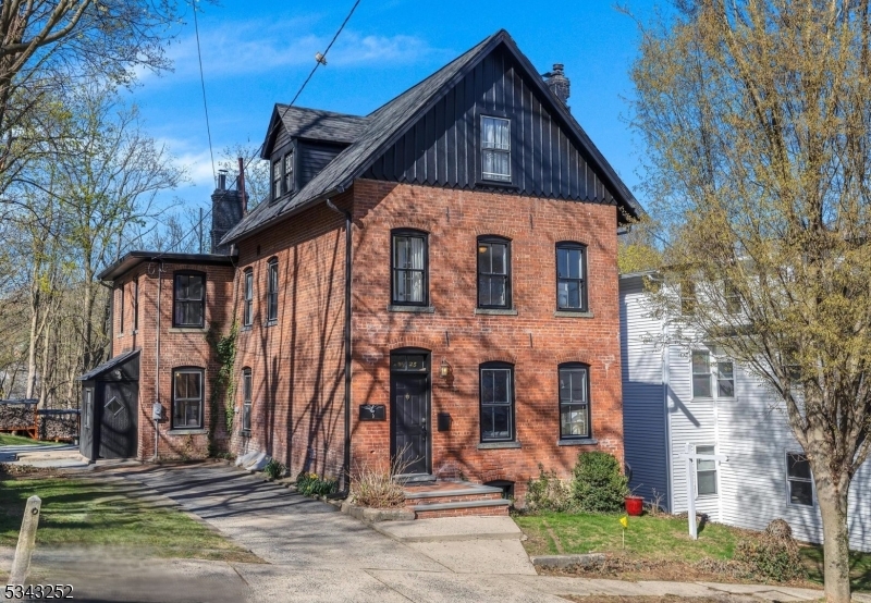 This elegant brick colonial in the heart of desirable Morristown is ready to be yours! Each update was thoughtfully finished with attention to craftmanship, historic details, and modern use. You'll love the beautiful wood floors throughout and the fully renovated kitchen is a cook's dream with a large island, fabulous antique-like gas stove, wood cabinets, shelving, and side entry to the driveway. The main level also has living and dining rooms, an office, a tucked away cute powder room, two staircases, an updated rear sunroom with a new glass door to the composite deck, paver stone patio, and a bonus deck in the backyard. On the second level, the fully renovated full bath compliments the four updated bedrooms. The third level has two bedrooms and a gorgeous brand-new full bath with skylights. The basement is freshly painted, electrical wiring has been updated, and the gas furnace was added in 2016. Enjoy living in Morristown with walkable streets, restaurants, shops, NJ Transit Midtown Direct train, world-renowned hospital, parks, and historical sites.
