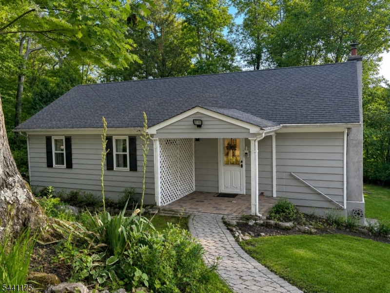 Tucked away on nearly   of an acre, this inviting 4-bedroom home blends privacy, charm, and versatility in a picturesque setting surrounded by mature trees and natural rock outcroppings. Hardwood floors, a fireplace, and an updated kitchen with stainless steel appliances, abundant cabinetry, and a center island create an ideal space for everyday living and entertaining.Four bedrooms are complemented by two bonus rooms upstairs, offering flexibility for a home office, gym, playroom, guest suite, or creative space. An updated full bath with double vanity and a spacious deck overlooking the park-like grounds further enhance the home's appeal. Smart-home features include a Ring video doorbell camera, smart lock, and smart switches throughout the living room and bathroom.Enjoy the best of both worlds peaceful surroundings with exceptional convenience just minutes from Routes 10, 46, and 80, NJ Transit rail service, shopping, dining, and parks. A rare opportunity in desirable Roxbury Township.