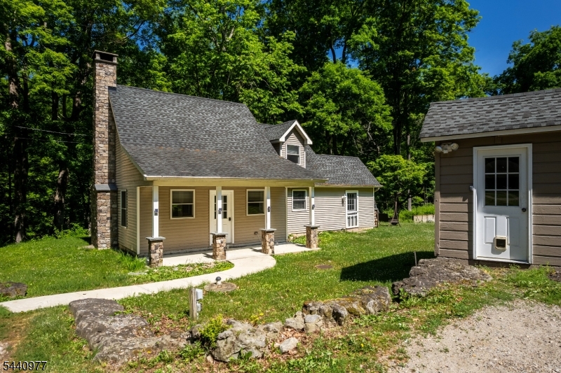Welcome to this beautifully renovated 2-bedroom, 1-bath single-family home nestled on a private, scenic lot in desirable Blairstown. This unique two-story custom home offers the perfect blend of rustic charm and modern updates. Step inside to find gorgeous flooring throughout, a spacious open floor plan, and a stunning stone wood-burning fireplace that serves as the heart of the home. The updated kitchen and living spaces provide comfortable everyday living, while the convenient first-floor laundry adds to the home's functionality. Upstairs, both bedrooms offer peaceful views of the surrounding landscape, creating a true retreat-like atmosphere. Enjoy the outdoors from the inviting covered front porch overlooking your own private oasis. The property also features access to part of the detached garage ideal for storage and a charming chicken coop ready for use if fresh eggs are on your wish list. Conveniently located with easy access to major highways, this one-of-a-kind rental offers privacy, character, and a tranquil setting that's hard to find. Don't miss this opportunity to enjoy country living with modern comforts.