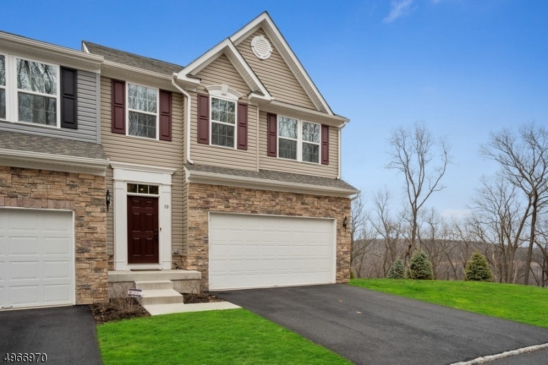 Perfection end unit w/ spectacular sunset views, mins to 80, 46, 10 & the new Mt Arlington Mid Town Direct. Full finished walk out. Open concept kitchen features granite counters, stone backsplash, ss appliances. 2nd Fl MBR features 2 walk in closets, en suite bath (see floor plan). Dual shower heads. molding package. $18,000 in upgrades Move in ready.