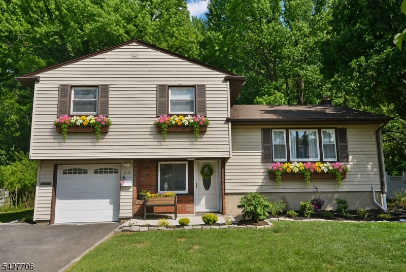 Private and pristine, nestled on a quiet picturesque cul-de-sac, this well cared for 3 Bedroom, 2 Full Bath home combines a serene setting w/ a list of meaningful updates. Over recent years, the owners have invested in a new roof, new plumbing, sewer line replacement, attic insulation, hot water heater, garage floor, and more interior improvements. Inside, the layout strikes the perfect balance between togetherness and personal space. The Living Room flows into the Dining Room, creating an easy backdrop for holidays, game nights, and everyday life. The updated Kitchen features granite countertops, new tile backsplash, breakfast bar seating, and newer appliances. A space designed as much for conversation as it is for cooking. Downstairs, the Family Room offers a full bath and sliding glass doors leading out to the covered patio, perfect for outdoor activities. Beyond it, the backyard backs to a woodland area, offering peaceful green serenity. New flooring on the ground & 1st floors and refinished hardwood floors upstairs. An attached garage & backyard shed provide extra storage every household appreciates. Plainfield offers 2 NJ Transit train stations & Cedar Brook Park's trails, sports fields, and historic Shakespeare Garden are close by for weekend mornings outside. Cook Elementary School is only a 3 minute drive away. Beautifully maintained, thoughtfully updated, & ready for its next chapter. It's the kind of home that feels right the moment you pull into the driveway!