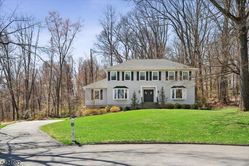 Set on a picturesque, tree-lined cul-de-sac, this beautifully maintained 4-bedroom, 2.1-bath Colonial offers the perfect blend of comfort, style, and functionality. A welcoming curb appeal leads into a warm and inviting interior featuring rich hardwood floors, abundant natural light, and thoughtfully updated spaces throughout. The main level offers elegant formal living and dining rooms, ideal for entertaining, along with a spacious family room highlighted by a striking floor-to-ceiling brick fireplace and sliding doors that open to the deck perfect for seamless indoor-outdoor living. The bright eat-in kitchen features granite countertops, stainless steel appliances, ample cabinetry, and both recessed and pendant lighting, with a sunny breakfast area overlooking the backyard.  A versatile first-floor office or optional guest bedroom adds flexibility to suit today's lifestyle needs. Upstairs, all bedrooms feature hardwood floors. The primary suite offers an updated bath with jetted tub, frameless glass shower, dual vanity, and granite finishes. The main bath includes a dual-sink vanity with granite and a tub/shower. The finished basement provides generous additional living space with access to the attached two-car garage. Enjoy the deck and spacious yard in a peaceful setting. Ideally located near shopping, dining, parks, and major commuting routes, this home also offers access to top-rated schools, making it an exceptional opportunity.