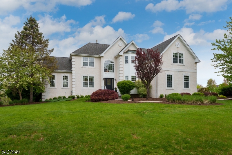 In the Estates of West Amwell, this original model home showcases the finest details and upgrades expected of a builder's showpiece home. Thoughtfully designed bump-outs enhance both space and light, while an extraordinary finished lower level elevates entertaining to an art form. Complete with a full bar, kegerator, full-size refrigerator, ice maker, microwave, and a full bath, this level opens through sliding doors to a resort-style pool and a sheltered patio with a mounted television. The gracious floor plan offers both front & rear staircases, four bedrooms, four full baths, and an additional powder room. Elegant formal living and dining rooms flow effortlessly into a sunlit conservatory, creating an ideal setting for both intimate gatherings and larger celebrations. The kitchen is equipped with double ovens, gas cooking, and a welcoming breakfast area, all opening to an expansive composite deck that overlooks the beautifully appointed outdoor spaces. Everyday living is equally well considered, with a spacious laundry room that provides direct access to a three-car garage, the powder room, and a home office. The primary suite features a tray ceiling, a separate sitting room, oversized W-I closet, & private bath. BRs 2 & 3 share a well-appointed Jack & Jill bath, while the 4th BR has its own private bath. Generous closets throughout complete this exceptional home, offering both style and substance in one of the area's most desirable communities near Lambertville/New Hope.