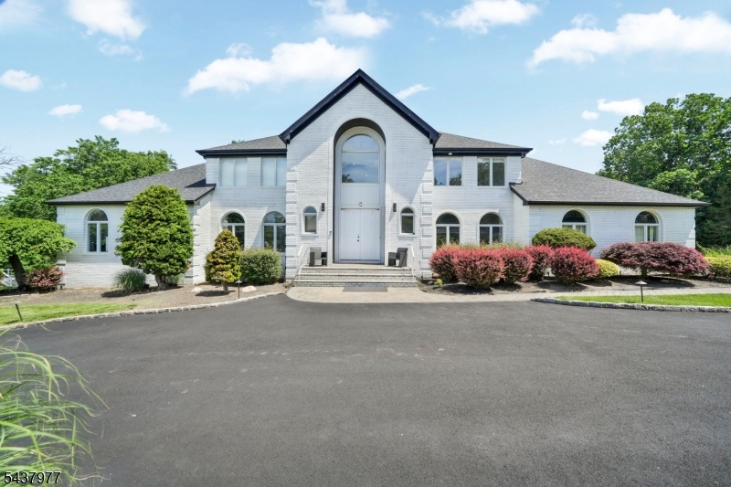 Welcome to this beautifully renovated Cambridge Model Colonial in one of Towaco's most desirable neighborhoods. Set on over an acre of professionally landscaped property with a spacious deck and private wooded backyard, this exceptional home offers the perfect blend of luxury, comfort, and privacy.A grand two-story foyer leads to a bright, open floor plan featuring a sun-filled great room with a wood-burning fireplace and wall of windows. The brand-new gourmet kitchen showcases custom cabinetry, premium finishes, and a thoughtful design ideal for entertaining. Renovated bathrooms, gleaming hardwood floors, and updated living spaces throughout make this home truly move-in ready.The second level features a luxurious primary suite with a walk-in closet and spa-inspired bath, along with three additional spacious bedrooms, including a princess suite.Major updates include a new kitchen, renovated bathrooms, new roof, gutters, and numerous improvements throughout. A rare opportunity to own a turnkey home in one of Towaco's premier neighborhoods.