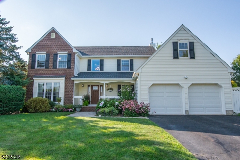 Bright & Sunny Colonial in Flanders Crossing, offering a spacious floor plan and nicely updated finishes. Walk up to this beautiful home and you're greeted by a sunny & private front porch,  ideal for sitting & enjoying your morning coffee & hear the birds sing. A 2-story foyer awaits you w/ custom moldings & ceramic tile floor. Open the French doors to the Living & Dining Rms w/ HW floors. Large Kitchen w/ Newer SS appliances. Cozy Family Rm w/ Wood Burning Fire place & step-down to the custom Sun Room w/ Hot Tub! Primary Rm has vaulted ceiling & full bath w/ soaking tub. Large Pantry/Wine Cellar in basement. Private deck & yard. Sprinkler system. Portable generator that powers the whole house included! Enjoy the community pool, tennis/pickle ball courts & Clubhouse! Don't Miss this beautiful Home!