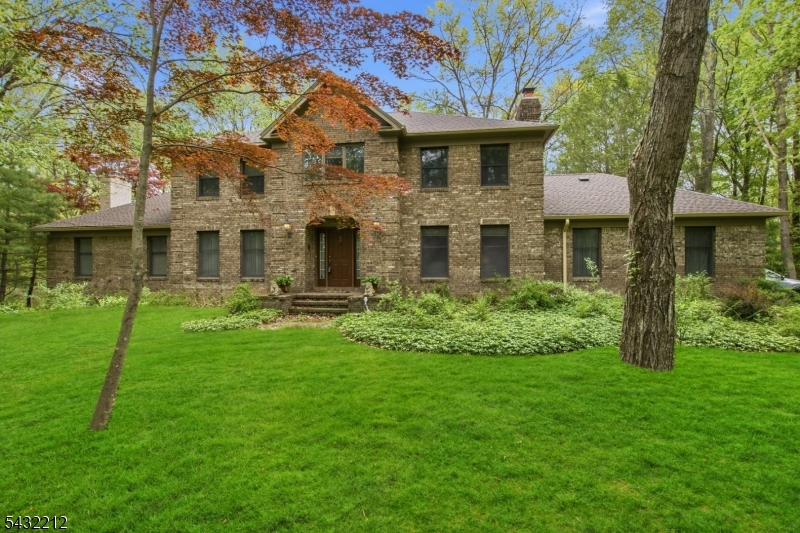 Don't miss this spacious 4-bedroom, 3 full bath Center Hall Colonial set on over 2 private acres in a desirable lower West Milford location. A grand 15x12 entry foyer with wood flooring welcomes you into this warm and inviting exceptional home. The large family room features custom crown molding, recessed lighting, paddle fan, and a beautiful brick fireplace with French doors leading to a full-length rear deck and patio perfect for entertaining or relaxing in the peaceful backyard setting. A second fireplace adds additional warmth and character to the living room. The second floor offers four generously sized bedrooms, all with newer windows and ceiling fans. One bedroom includes custom wall-to-wall built-ins with abundant shelving and extra closet space. The primary suite features recessed lighting, a walk-in closet, and an updated en-suite bath with dual sinks, jetted tub, and separate shower. The main bath includes an oversized vanity and convenient bidet. Additional highlights include a newer furnace, updated baths, kitchen breakfast area, main floor laundry, and a bonus sitting room ideal for a home office or guest space. The full basement offers high ceilings and excellent finishing potential. A long private driveway provides added convenience and exceptional privacy. With a little TLC, this home can become your dream home. Exceptional value for the size, setting, and location. Don't miss this opportunity!