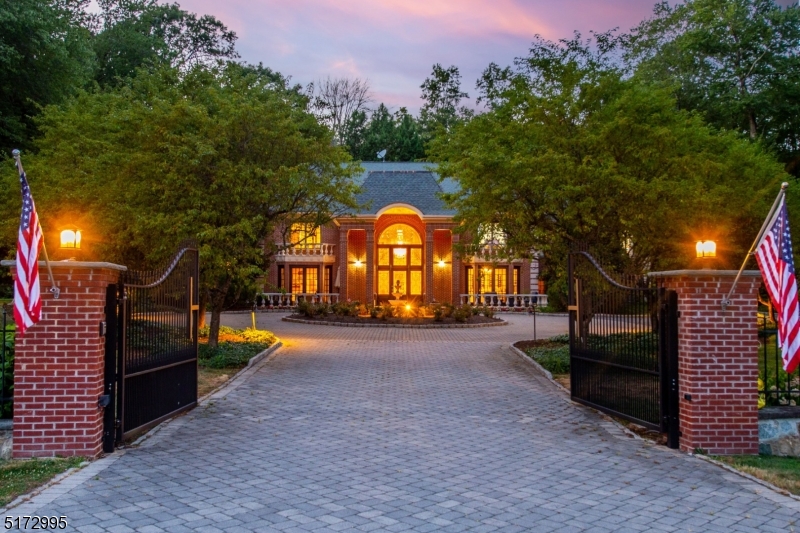 This fine luxury estate truly has it all with over 7,000 sq ft on over 2 acres of lush tranquil grounds. This is the one, from the state of the art movie theatre, to fully equipped pool house that can be used as a guest house. Enter through the gated entrance and into the grand 2 story front porch that leads to a dramatic butterfly staircase. First floor offers one level living floor plan, gourmet chefs kitchen with a double island, high end appliances, and a breakfast nook overlooking the massive pool. A great room with floor to ceiling windows that lead to the private backyard, sitting room that has been converted into an enclosed wine room with exit into the front porch, billiards room, a guest suit and laundry room. First floor primary suite includes 2 WIC, fireplace, a luxurious primary bath with a steam shower and a jetted tub. Second level has a large open space living area, 4 additional bedrooms that all have WIC and their own private bathrooms. Third level has been converted into a movie theatre with surround sound, powder room and living room with a bar just outside the enclosed movie theatre. Enter into the peaceful, relaxing backyard that has a heated gunite swimming pool with spa, gazebo overlook freshwater pond and a fully equipped pool house. Pool house has a full kitchen, private bedroom, full bath & living area. Speakers throughout, generator & water softener. High rated schools. TAXES ARE NOW UNDER $24,000