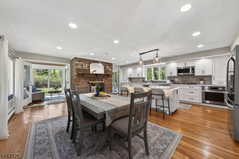 Welcome to 28 Spring Ridge Drive - one of Berkeley Heights' most coveted addresses. From the moment you arrive, this home announces itself differently. Spring Ridge Drive is a neighborhood people wait years to call home, & this 4-bedroom, 3-bath property shows exactly why. The main level is where the magic lives. The living room, kitchen, & sunroom flow into one another with an ease & warmth that stops people mid-tour. It's a space that makes you understand immediately what it would feel like to live here. The kitchen earns every superlative. A stunning bay window floods the space w/ morning light while the gas fireplace keeps everything warm & inviting. The large island anchors it all - wide enough for busy mornings, elegant enough for everything else. The sunroom flows directly off the kitchen, an effortless extension where coffee lingers & mornings slow down. An updated laundry room & pantry complete the level. The wood-paneled family room invites you to settle in. Warm & generous, w/ a full wet bar, this space was made for game nights, holiday gatherings, & everything in between. The finished basement offers endless flexibility. Upstairs, 3 sun-drenched bedrooms offer comfort & light. A private primary suite occupies its own level - quiet, removed, & entirely yours. Outside, a private, flat backyard made for summer barbecues, play, & peaceful evenings to simply relax. Thomas Hughes Elementary is just blocks away, adding to the everyday ease of this exceptional location.