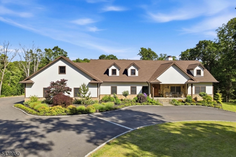 Expanded Ranch Living Redefined And Set On 1.5 Acres In Lower West Milford, This Thoughtfully Designed Residence Blends Open-Concept Living With Exceptional Functionality. The Heart Of The Home Is A Dramatic Great Room Featuring Soaring Cathedral Ceilings, Rich Flooring, And A Floor-To-Ceiling Stone Wood-Burning Fireplace That Connects The Living, Dining, And Kitchen Spaces. Designed For Gathering, The Kitchen Offers A Center Island With Seating, Premium Appliances, And Designer Lighting That Elevates The Entire Space. The Primary Suite Is A True Retreat, With Dual Walk-In Closets And A Spa-Inspired Bath Featuring A Freestanding Soaking Tub, Oversized Glass-Enclosed Shower, And Double Vanity. 2 Additional Bedrooms, A Stylish Hall Bath, Dedicated Home Office, And A 20'x10' Laundry Room Complete The Main Level. Sliding Doors Open To An Expansive Deck Overlooking The Fenced Backyard, Creating Indoor-Outdoor Lifestyle. The Lower Level Expands The Possibilities With A Massive Recreation Room Centered Around A Second Stone Fireplace, Plus Abundant Flexible Spaces For Future Customization. Storage Is Unparalleled With A Walk-Up Attic, Multiple Storage Rooms, And A 21'x6' Storage Area Adjoining The Attached Two-Car Garage. An Oversized Detached Garage Provides Room For Vehicles, Equipment, Recreational Toys, Or Workshop Space. Commuters Will Appreciate Convenient Access To Route 23 And Being Just 25 Minutes From Warwick, NY. A Rare Combination Of Scale, Quality, Storage & Lifestyle.