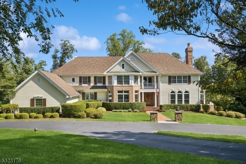 Experience gracious living in this Bocina-built masterpiece, perfectly positioned on a quiet cul-de-sac w sweeping views of the Bernardsville Mountain and adjacent to 34 acres of town-protected land. This residence boasts a modern, open floor plan designed for both elegant everyday living and exceptional entertaining. Step through a welcoming foyer featuring a grand imperial staircase that leads into a luminous living room w a wood-burning fireplace. The spacious dining room is ideal for hosting large gatherings, while the gourmet kitchen completely renovated in 2016 delights with professional-grade appliances, a center island, breakfast bar. Additional highlights on the main level include a home office or library, a  sunroom, bar room, and a cozy family room w/ stone fireplace. This level flows effortlessly onto a sprawling deck that overlooks a private outdoor oasis.The lower level walk-out is an entertainer's dream, featuring a summer kitchen and glass doors opening to a Gunite, saltwater pool, complemented by a gas fire pit and outdoor kitchen perfect for alfresco dining and relaxation. Upstairs, there are 5 spacious bedrooms provide ample privacy and comfort.  A bonus room with a full bath on the lower level offers flexible living options. Upgrades include exterior painting '22 and a secondary bath in '20, summer kitchen 2016, and new pool, hardscape, and outdoor kitchen in '15. All of this just 2 miles from the vibrant town center, complete w train/bus service to NYC