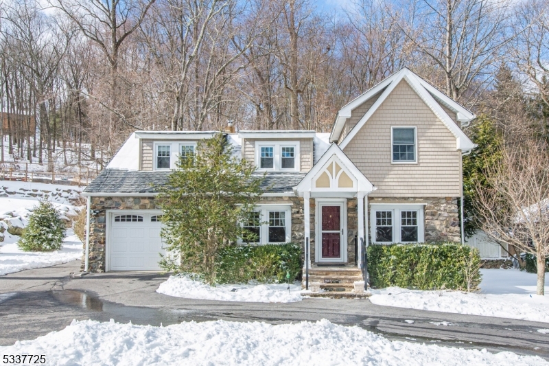 Charming and quaint, this adorable Colonial-style home blends timeless appeal with modern comfort. Featuring beautiful stone, this home offers a warm and inviting exterior that immediately captivates. Inside, you'll find a spacious and open living & dining room with a beautiful stone wood-burning fireplace. Quaint Kitchen & family room with breakfast bar, and sliding door to patio. Main floor full bath. Upstairs you'll find the Primary bedroom with an en-suite bath and walk-in closet. Two additional bedrooms with Jack & Jill Bath. All bedrooms are very spacious providing ample room for relaxation and have generous-sized closets, including 2 walk-in closets. All three full baths are beautifully appointed with elegant tile work, offering a touch of luxury throughout. The property has a circular driveway, ensuring plenty of parking and a welcoming entrance. Outside, the fenced-in yard overlooking the woods is perfect for privacy, with a lovely patio ideal for entertaining or enjoying peaceful moments outdoors. This delightful home is ready to offer comfort and style in a serene setting! A NEW 3BR SEPTIC is in the process of being installed! Hardwood floors throughout. Newer Roof & Windows. Central AC. Well-insulated and well cared for home. Nothing to do but move in! Don't miss it!