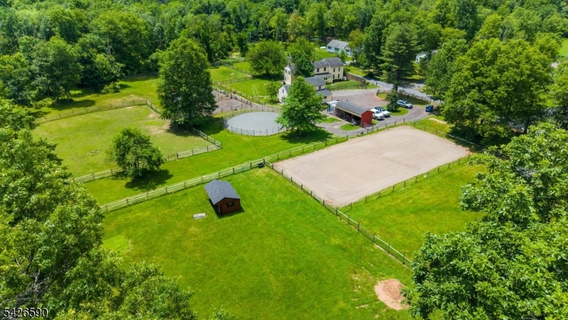 Set on four acres, 179 Lindbergh Road is more than a home; it is a rare opportunity to own a piece of New Jersey history with horse facilities. The home itself is a remarkable homestead that blends centuries of character with the comforts of everyday living. Inside, discover hand-hewn beams, wide plank floors, and architectural details that reflect generations of craftsmanship. The kitchen and gathering spaces flow naturally together, making the home feel both welcoming and functional. Adding to the property's appeal is the converted Carriage House. The lower level is utilized as a garage space and workshop with electric and heat. On the second level, a finished bonus room features pine floors, electric, dedicated heating, and additional storage space. Outside, the equestrian amenities have been thoughtfully designed. With six stalls total, one set features direct run-outs into private dry lots (two with their own water source) with access to private green pastures. Electric connectivity runs to four of the stalls, and a 60-foot round pen features professional-grade stone dust footing. A regulation-size small dressage arena was built with professional footing. A portion of the property is double-fenced and features classic split-rail fencing. The 3-Bay Equipment/Hay Barn sits directly on the footprint of the original historic barn. Offering timeless character, peaceful surroundings, it's time to become part of a story more than two centuries in the making.