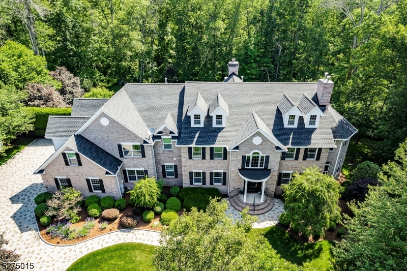 Tucked away in a serene cul-de-sac, this exquisite custom brick colonial is a must see that sits on nearly 6 acres of lush greenery, adorned with mature trees and vibrant plantings.  This beautiful home includes six bedrooms - five bedrooms plus a media room and recreation room on the second level - and an additional bedroom and full bath on the first level.  Boasting an array of luxurious features, including soaring ceilings, a 4-car garage, 4 cozy fireplaces, a refreshing pool with a charming cabana, a pavilion with fireplace and outdoor kitchen, and a sophisticated wine cellar, the spacious layout is even further enhanced by intricate moldings.  The home also features a handsome wood-paneled library, a bright sunroom, a generous eat-in chef's kitchen equipped with top-of-the-line appliances, an elevator that conveniently serves all three levels, and a full house generator for added convenience.  A fully-finished basement offering a sizable exercise room, a dance studio, and another full bath completes this amazing space.