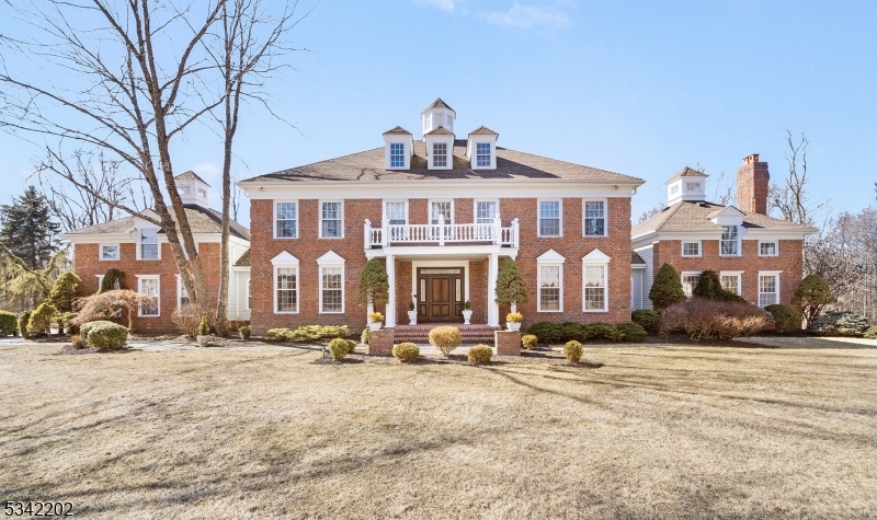 Welcome to "Il Tempo Vola" (Time Flies)--an absolutely breathtaking, one-owner, brick front Center Hall Colonial with a European flair, and set back beautifully on a pancake flat 3-acre corner lot in a coveted east Mendham Township estate neighborhood.  This wonderful home has an expansive 6,012 sq ft floor plan with seamless flow, plus the added utility & convenience of a sprawling, fully carpeted finished lower level.12 rooms comprising 5 airy bedrooms, cloistered guest/au pair suite, 6 1/2 baths, 3 fireplaces; enthralling great room with a soaring 27' architectural ceiling topped by a lighted cupola; exceptional open floor plan sunken family room w built-in breakfast bar separating it from the light, bright, & open designer kitchen boasting custom wood cabinetry, ample counter space, large center island with galley seating, premium appliances, & a roomy eat-in dining area with access to the rear deck; elegant formal dining room replete with coffered ceiling, stylish wainscoting, & crystal center chandelier, plus a nearby butler's pantry; impressive library with coffered ceiling & adorned with mahogany paneled walls and floor-to-ceiling bookcases; completing the first floor is an attractive full bath, powder room, & convenient mudroom with access to the 3-car garage and rear yard, plus back staircase to 2nd floor.Second floor has a sweeping stairway leading to a wide, curved landing w a jaw-dropping 27' domed ceiling capped by lighted cupola: 5 airy bedrooms, 4 full baths