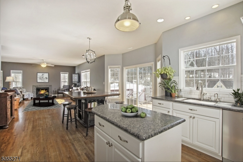 This 4 plus bedroom center hall colonial with open floor design gives way to beautiful views from all levels. The high-end kitchen with large center island, separate eating area, granite countertops & SS appliances flow into the entertainment size family room with fireplace & pellet stove! Hardwood floors are throughout this light & bright home with two many unique features to mention including central boiler wood burning stove and generator hookup. The rocking chair front porch looks out to private naturistic views and surrounded by over 4 acres of wooded park like property. The desirable commuter location is close to major roadways, shopping, dining & mass transit.
