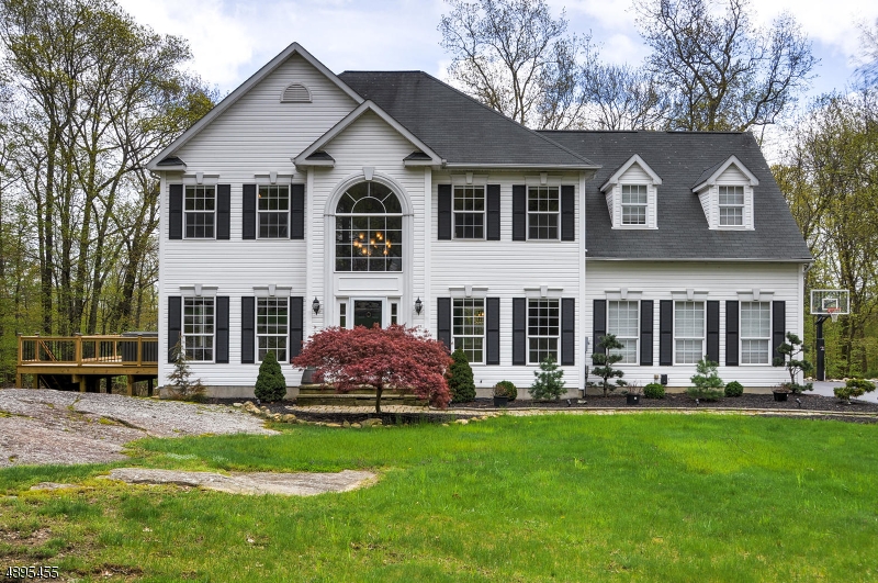 IMPECCABLY MAINTAINED 4 BED, 2.1 BATH COLONIAL ON 1.14 ACRES! This meticulous home has a welcoming, bright, wonderful flow. Gleaming freshly finished hardwood flooring throughout 1st level. Beautifully updated kitchen with ample cabinetry, granite and center island. Large living room with newly re-faced gas fireplace and many windows to enjoy the delightful backyard view. Large master bedroom with sitting room and oversized walk in closet. Walk out basement to paver patio leading to the flat, deep, private backyard. 40x16 deck wraps around side of house where the large hot tub is located. A MUST SEE!