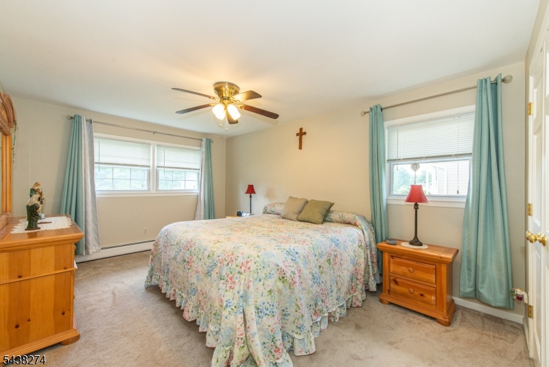 Beautifully updated home on 1/2 acre level lot in top neighborhood. Updated kitchen with granite counters. Updated main bathroom. Hardwood floors on main level, under carpet on 2nd level. Finished basement with rec room and office. Central Vacuum. Overhead lighting in every room. Ceiling fans in most rooms.  Walk-in closet in master bedroom. Replacement thermal windows. 3 year old roof. 6 year old deck and paver patio overlooking the 1/2 acre lot with 2 large sheds. Great location within minutes of shopping, dining, schools, Routes 10, 46, 80 & 206 plus the Mount Arlington Train Station. Down the street from Kennedy Elementary School. Less than 2 miles to Horseshoe Lake Complex & beach!