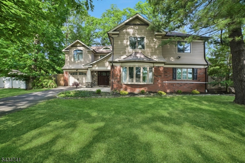 Set back on a nearly 1/2 acre, park-like lot in highly sought-after North Edison?renowned for its top-rated schools?this custom-expanded 6-bedroom, 3-bath home offers approx. 3,200 sq ft of spacious, move-in ready living in a prime commuter location. The flexible layout includes a first-floor bedroom with access to a full bath, ideal for guests, extended stays, or a private home office, while five additional bedrooms upstairs provide comfortable separation and privacy. Generous room sizes throughout offer versatility for a variety of living needs. The heart of the home is a large, open-concept kitchen featuring custom cabinetry, soapstone countertops, a farmhouse sink, and a center island flanked by built-in seating is perfect for everyday cooking and entertaining. The kitchen flows seamlessly into expansive living and dining areas with 2 fireplaces, creating a warm and inviting gathering space. A built-in window seat overlooks the fully fenced backyard and deep, usable property. Upstairs, five well-proportioned bedrooms and ample closet space enhance everyday functionality. Spa-inspired bathrooms feature elegant tilework, pedestal and vessel sinks, and a freestanding soaking tub.  A full basement, garage, and private, tree-lined setting complete the offering that's conveniently located near major highways, shopping, places of worship, and direct trains to NYC. A rare opportunity to own a spacious, well-located home in one of North Edison?s most desirable neighborhoods.
