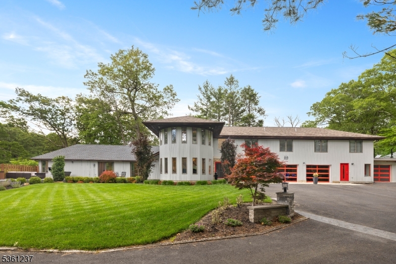 Impeccable Custom Contemporary nestled in one of Morris County's most desirable towns. Truly an oasis of peace & privacy -truly unique & architecturally captivating home. 10+ rooms across 4200 plus sqft of sophisticated living. Professional designed w/ functionality & entertaining in mind. Open, main living areas w/15' vaulted ceilings, walls of windows, skylights, striking modern-design chef's kitchen w/ many high end appliances & a formal dining. Upstairs, 4 generous sized bdrms & 2 full baths. Including the cloistered primary suite replete with 2 entrances, a large dressing room & exquisite primary bath. Zen garden with soaking tub & outdoor balcony! Sprawling expansive entertainment areas throughout, recreation, workshop, theater with recliners & many sitting areas accompanied by wine fridges.  An abundance of windows throughout provide a beautiful ambience & tons of natural light. The 5 patios / decks areas over the property is a priceless addition to this home -above ground pool & pool house. FOUR car garage perfect for the car enthusiast! Radiant heated driveway pad. Workshop with another full bath. Many amazing features throughout this custom home. Picturesque wooded setting on quiet, gated property! Nearly an acre. Experience tranquility, luxury & privacy right in your own backyard w/all the conveniences of NYC mass transit, easy access to major hwys. Close to Downtown Denville & Boonton Main Street. TOP Schools!
