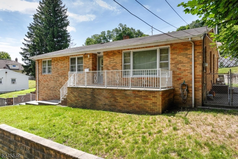 Step into timeless mid-century charm with this beautifully preserved and lovingly maintained brick ranch. Each time you pull into your oversized driveway, you will appreciate the well built hardscaping which add curb appeal and yard space. Enjoy the convenience of the oversized garage and bring your rocking chair for mornings and evenings on the front porch.  The original character includes gleaming hardwood, a large eat in kitchen and plenty of room for entertaining. Slip away into the roomy bedrooms providing plenty of space and comfy carpeting protecting the hardwood underneath.  Situated just minutes from William Paterson College, shopping and mass transportation adds hours to each day to enjoy your own home, yard and life.  Don't miss this value packed gem at a value packed price!