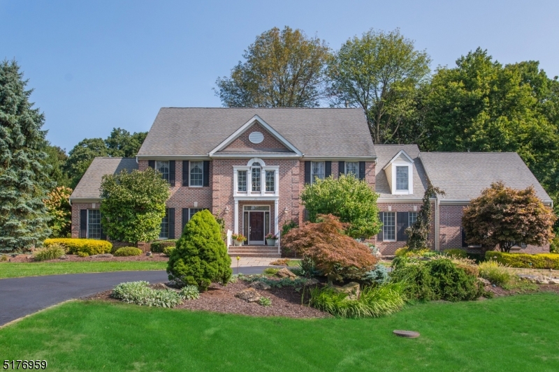 Look no further!  Fantastic Grandview Estates center hall colonial offers all you have been looking for! Circular drive leads to brick-front colonial, featuring professional landscape with lighting, gorgeous multi-level paver patio, perfect for entertaining.  Grand 2-story foyer with curved staircase welcomes you to an open and functional floorplan, offering formal living and dining rooms with extensive moldings, hardwood flooring, butler's pantry, chef's delight kitchen with center island, large breakfast area, 2 pantries, double wall ovens, granite counter tops and more. Family room with marble surround gas fireplace, conservatory with multiple use options, first floor office with closet and adjacent full bath, as well as foyer guest powder room, upgraded laundry with washer and dryer with pedestals, complete the first floor.  Second floor features Brazilian cherry flooring throughout, four spacious bedrooms, including en suite guest room with tub shower, Jack and Jill set-up with full bath, primary en suite with sitting room, exercise room and luxurious bath, including double vanity, stall shower, jetted tub and water closet.  Unfinished basement has limitless possibilities.  Other features include central vacuum, 14kw automatic generator, two HVAC units with multi-zone heating and cooling, two newer water heaters, invisible dog fence, window blinds and shades, finished garage with openers and much, much more. West Morris Central High School with IB program and WT schools.