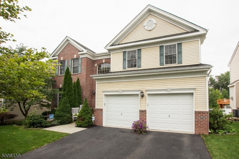 This meticulously maintained home has much to offer!  Open floor plan, cathedral ceilings, hardwood floors, and walk-out finished basement with a full bath and office /5th bedroom make for a perfect in law suite or just additional entertaining space. These are just some of the finer points of this home! The gourmet kitchen with full size double ovens, granite counters,and an abundance of cabinets and large breakfast area open to family room, with sliders to deck that overlooks large fenced in yard for privacy. Family room is 2 story with recessed lighting and gas fireplace and has access to laundry and 2 car garages. 2nd floor offers 3 spacious bedrooms plus master suite with walk in closet and spa like bath. Minutes to Rt. 80, dining, shopping and NJ transit train.