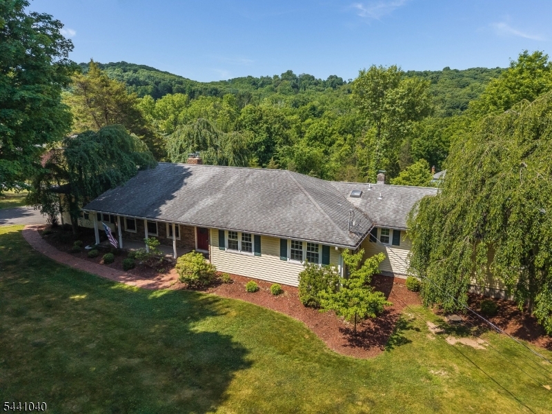 BEAUTIFUL EXPANDED RANCH ON 2+ ACRES IN DESIRABLE RARITAN TOWNSHIP!  THIS PRETTY 4 BEDROOM, 3 FULL BATH HOME OFFERS SPACE, COMFORT, AND VERSATILITY WITH A WONDERFUL IN-LAW SUITE AND RESORT-LIKE BACKYARD!  AN INVITING COVERED PORCH WELCOMES YOU INTO THE FOYER, LEADING TO A FORMAL DINING ROOM AND A SPACIOUS LIVING ROOM FEATURING A WOOD-BURNING FIREPLACE ACCENTED BY ELEGANT FRENCH DOORS. THE GOURMET KITCHEN BOASTS STAINLESS STEEL APPLIANCES AND A SUNNY BREAKFAST ROOM WITH ACCESS TO AN OVERSIZED DECK .  ENJOY ADDITIONAL LIVING SPACE WITH A SEPARATE SITTING ROOM AND A RELAXING HOT TUB ROOM THAT OPENS TO A SECOND OVERSIZED DECK OVERLOOKING THE BEAUTIFUL PROPERTY. HOT TUB IS WORKING BUT AS IS CONDITION. THE MAIN LEVEL FEATURES A PRIMARY BEDROOM WITH PRIVATE FULL BATH, TWO ADDITIONAL NICELY APPOINTED BEDROOMS, ANOTHER FULL BATH,  AND A CONVENIENT LAUNDRY ROOM WITH DECK ACCESS . DAYLIGHT WALKOUT GROUND  LEVEL OFFERS EXCEPTIONAL FLEXIBILITY WITH AN IN-LAW SUITE COMPLETE WITH A BEDROOM, FULL BATH, AND LIVING ROOM.  ADDITIONAL FEATURES INCLUDE A GAME ROOM, BONUS ROOM , STORAGE AREA, AND UTILITY ROOM.  STEP OUTSIDE TO ENJOY THE BEAUTIFULLY LANDSCAPED 2+ ACRE PROPERTY FEATURING A STUNNING HEATED IN-GROUND POOL, SPACIOUS PATIO, AND PLENTY OF ROOM TO RELAX OR ENTERTAIN. CONVENIENTLY LOCATED JUST MINUTES FROM HISTORIC FLEMINGTON, LOCAL FARMS, SHOPPING, RESTAURANTS, AND ALL THAT HUNTERDON COUNTY HAS TO OFFER! DON'T MISS THIS INCREDIBLE OPPORTUNITY TO OWN A SPACIOUS HOME WITH ROOM FOR EVERYONE!