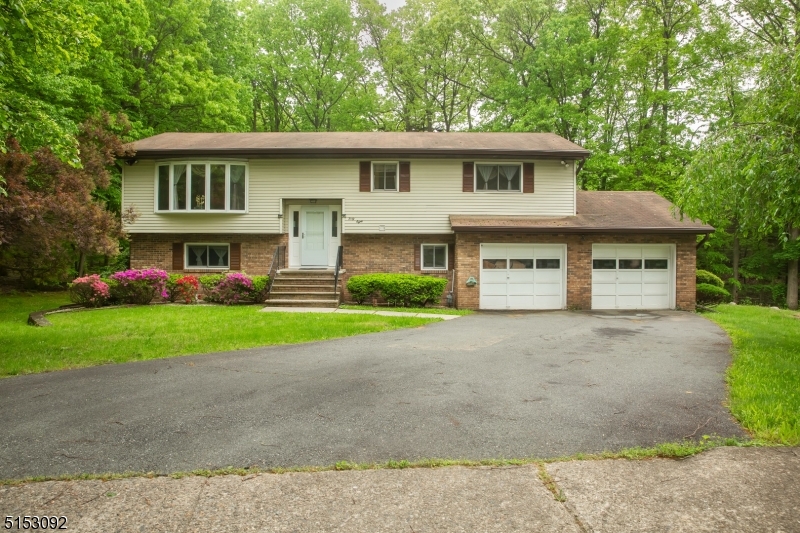 THIS IS IT...THE ONE YOU HAVE BEEN LOOKING FOR! This house has it ALL!  A BI-LEVEL house located at the end of the street on a cul-de-sac with a FULL INL-LAW SUITE!  This home offers space galore with 5 bdrm and 3 full baths.  This picture perfect home located in one of Parsippany's sought-out neighborhood, Rainbow Lakes.  Located on .6 acres and the driveway is equipped to park 6-8 cars comfortably; not to mention all the on-street parking in the cul-de-sac.  The current homeowners purchased the property from the original builder and have meticulously maintained the property throughout the years.  New hardwood flooring throughout the entire upstairs including the kitchen.  The kitchen was renovated with custom wood cabinets, granite countertops with full tile backsplash and a center island with granite counter space.  Recessed ceiling lights were installed in the kitchen, dining area and living room.  In addition to the kitchen renovation, new central air ducts were installed as well as a new air conditioner and hot water heater 3-4 years ago.  Updated main bath with generous sized bedrooms on the main level.  Enjoy an enormous sized family room and In-Law Suite on the lower level.  Access to the back 2-tier deck located on both levels; one from the kitchen and one on the lower level in the family room.  This home offers a BIG BEAUTIFUL backyard and is next to a beautiful forest that would be ideal for summer barbecues and get togethers!  DON'T LET THIS HOUSE PASS YOU BY!!!