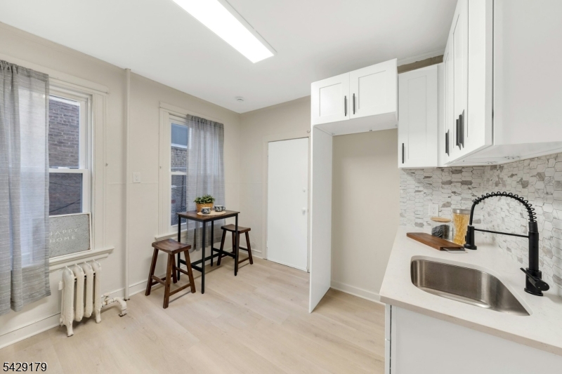 Beautifully and tastefully renovated, this 3 bedroom, 1.5 bath townhouse style brownstone offers exceptional value and true move in ready convenience. No expense was spared in the renovation, blending modern updates with timeless character throughout. The spacious layout features an eat-in kitchen, separate dining area, comfortable living room, and a dedicated office space perfect for working from home or added flexibility. Step outside to enjoy a private backyard ideal for entertaining, relaxing, or everyday use. Conveniently located close to schools, houses of worship, shopping, and major transportation, including direct access to New York City. A true turnkey opportunity just move your furniture in and enjoy. 12 month parking across the street already paid for, Seller is offering concessions towards closing cost.